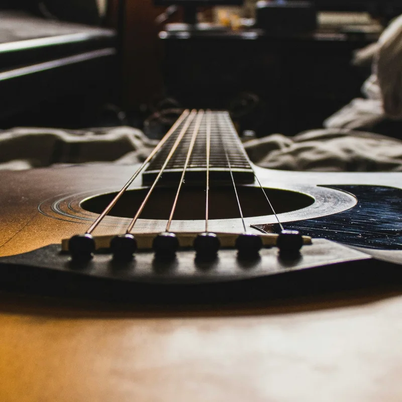 Close-up of an acoustic guitar, strings in focus